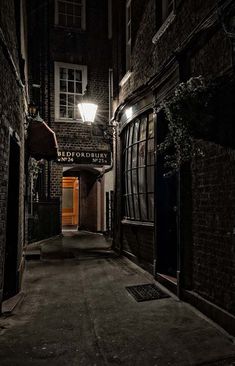 an alleyway at night with the lights on