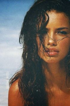 a woman with wet hair standing in the water