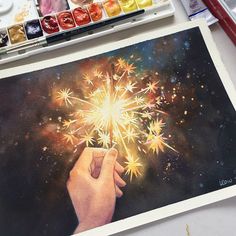 a painting of a hand holding a firework in front of some paintbrushes