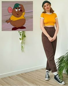 a woman standing in front of a wall with an image of a cartoon character on it