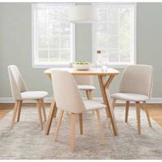 a dining room table with four chairs around it