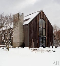 an old barn in the middle of winter with snow on the ground