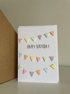 a happy birthday card with bunting flags