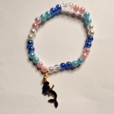 Pink, Blue, Clear, And Pearl With Mermaid Charm Made With Durable Elastic Band Adjustable Blue Beaded Bracelet With Pearl Charm, Mermaid Beads Jewelry, Adjustable Pink Bracelets With Pearl Charm, Mermaid Beaded Bracelet, Beach Charm Bracelet, Adjustable Hand-strung Blue Pearl Bracelet, Snowflake Bracelet, Fork Bracelet, Puffy Heart Charms