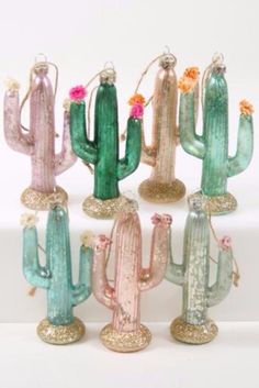 six glass cactus ornaments in different colors and sizes