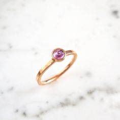 A sweet pink rose cut sapphire in a timeless bezel with a flat 14k rose gold flat band. An everyday piece, in addition to, stacking with other rings for a unique, bold look. genuine pink Sapphire Magenta/Pink Sapphire - Rose Cut faceted sapphire 4 mm round Flat Band Recycled 14 k Rose Gold Ready to ship in Size 7 - Sizable, please message us for a quote. :: please message us for any specifications, time frames, and or change of address. This ring can also be hammered and/or have a matte finish. Everyday Rose Gold Stackable Rings With Bezel Setting, Rose Gold Stackable Rings With Bezel Setting, 14k Rose Gold Stackable Rings With Bezel Setting, Pink Sapphire Ring In 14k Rose Gold As Gift, Rose Gold Pink Sapphire Stackable Rings For Anniversary, Rose Gold Stackable Rings With Pink Sapphire For Anniversary, Fine Jewelry Rose Gold Pink Sapphire Ring, Rose Gold Pink Sapphire Ring Fine Jewelry, Anniversary Rose Gold Stackable Rings With Pink Sapphire