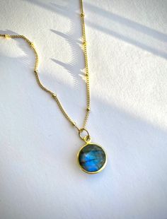 A delicate 14kt gold filled satellite necklace with a genuine blue labradorite pendant. A carefully selected and high quality labradorite crystal makes this necklace truly beautiful and one of a kind. The delicate and minimalist design of the necklace goes well with both casual and sophisticated looks. Perfect for a gift. ✦ MATERIALS ✦ 14kt gold filled satellite chain. Labradorite bezel pendant. LABRADORITE helps with reducing negativity, tempering impulsivity and recklessness, aiding in intuiti Gold Labradorite Round Jewelry, Gold Round Labradorite Jewelry, Dainty Labradorite Jewelry For Everyday, Gold Labradorite Everyday Jewelry, Everyday Gold Labradorite Jewelry, Dainty Labradorite Pendant Necklace, Gold Labradorite Necklaces As Gift, Gold Labradorite Necklaces For Gifts, Gold Labradorite Necklace For A Gift