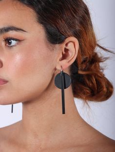 Expertly crafted from premium cowhide leather and 925 silver plated mini hoops, these Dot Line Mini Hoop Earrings by Aumorfia add a touch of sophistication to any outfit. The unique design features a dot and a line hanging from a sterling hoop. Handmade in Greece by their local craftsmen. Dimensions: 1" x 3"Dimensions(hoop): .5" Minimalist Black Jewelry With Leather Strap, Minimalist Black Leather Jewelry, Modern Black Small Hoop Jewelry, Modern Adjustable Black Earrings, Minimalist Leather Earrings For Everyday, Handmade Leather Hoop Earrings, Black Minimalist Handmade Hoop Earrings, Black Leather Earrings As A Gift, Modern Black Handmade Hoop Earrings