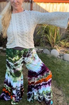 Made from 100% woven Rayon Light, these tiered pants have bohemian flare!   Comfortable and easy to wear with elastic waistband and two gathered tiers in the pant legs.  US Women's size Medium. Sizes run on the bigger side, see sizing photo chart for best fit. Hippie Style Fall Festival Pants, Hippie Fall Festival Pants, Bohemian Fall Festival Bottoms, Hippie Boho Print Vacation Bottoms, Bohemian Harem Pants For Fall Festival, White Hippie Bottoms For Summer, White Bohemian Pants With Elastic Waistband, Bohemian Boho Print Pants For Vacation, Bohemian Style Flare Bottoms For Fall