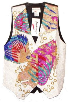 This sequin vest is handmade, high quality, original design and beautiful. Sequin vests are suitable for party, events or any occasional use. All sequin vests close with snaps in the front and the back is solid black with a strap to adjust the vest to your desired fit. Glamorous Summer Vest With Sequins, Glamorous Party Vest With Sequins, Sequined Fitted Vest For Spring, Fitted Sequin Vest For Spring, Fitted Sleeveless Vest For Festival, Sleeveless Sequin Vest For Party Season, Glamorous Sequined Vest For Spring, Fitted Sequin Vest For Party Season, Fitted Embellished Vest For Fall