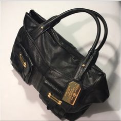 Large Leather Bag Black With Gold Tone Hardware Used In Good Condition Without Holes Or Stains Or Foul Odors. The Two Straps Shows Signs Of Normal Wear. Straps Are 7 Inches Long And The Purse Size Is 16x10x7. Inside Have 1 Zipper Pocket And Two Slip Pockets And One Large Snap Pocket. Two Pockets On The Outside. Magnetic Closure Designer Office Bags With Brass Hardware, Designer Office Bag With Brass Hardware, Designer Workwear Satchel With Brass Hardware, Black Leather Bags With Brass Hardware, Elegant Black Bag With Brass Hardware, Elegant Black Bags With Brass Hardware, Elegant Black Shoulder Bag With Brass Hardware, Black Satchel With Brass Hardware For Work, Black Business Bags With Brass Hardware