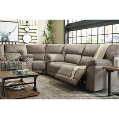 a living room with a sectional couch and coffee table