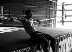 a man sitting on top of a wrestling ring