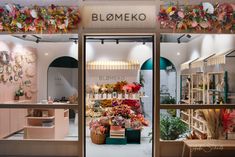 a flower shop with lots of flowers in the window