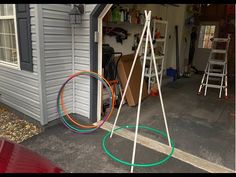 two hoop rings are in front of a garage with other items on the ground outside