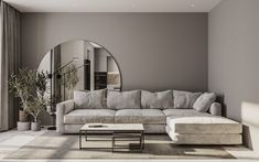 a living room filled with furniture and a large round mirror on the wall above it