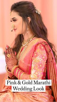 a woman in a pink and gold sari holding her hands together with the words pink & gold maraah wedding look