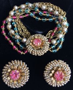 "Here is a spectacular vintage multi-strand bracelet and earrings set by designer Miriam Haskell. The bracelet is composed of six enchanting strands, three of which are fashioned with glistening and translucent glass beads in a gorgeous aqua blue and a luscious cranberry tone, a single strand crafted of gleaming faux pearls and two strands of gold tone double link chains that exhibit an attractive, warm golden patina. The glass beads and pearls are all gilt filigree capped and linked in-between Vintage Pearl Jewelry, Miriam Haskell Jewelry, Translucent Glass, Multi Strand Bracelet, Miriam Haskell, Bracelet Earring Set, Fashion Jewelry Sets, Retro Jewelry, Old Jewelry