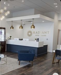 an office lobby with blue chairs and lights