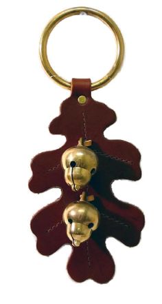 a key chain with two gold faces on it