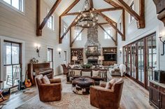 a living room filled with lots of furniture and a fire place in the middle of it