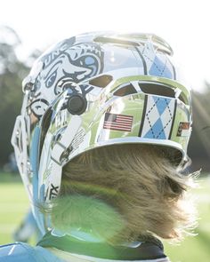 a close up of a person wearing a helmet with an american flag design on it