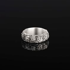 a white gold wedding band with roses on it