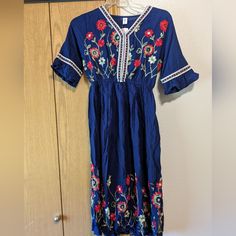 New With Tags, Beautiful Embroidered Floral Pattern Dress. Navy Blue Size Small. Blue Floral Print Embroidered Summer Dress, Summer Blue Embroidered Floral Print Dress, Blue Floral Print Embroidered Midi Dress, Blue V-neck Dress With Embroidered Hem, Blue Spring Dress With Embroidered Hem, Casual Blue Embroidered Dress For Vacation, Blue Cotton Dress With Floral Embroidery, Blue Dress With Embroidered Hem For Spring, Casual Maxi Embroidered Dress With Floral Detail