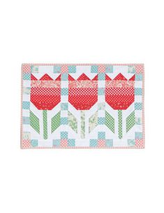 three red tulips on a blue and white checkered tablecloth with the words happy