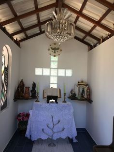 a room with a table and chandelier in it