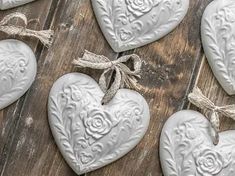 heart shaped ceramic ornaments tied with twine on wooden table top in rustic style setting