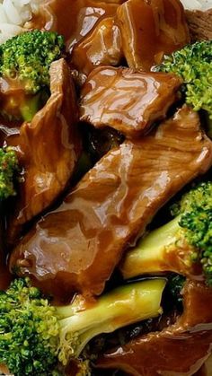 beef and broccoli with sauce on top of rice