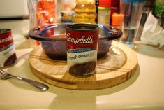 a can of campbell's chocolate pudding on a cutting board next to a spoon