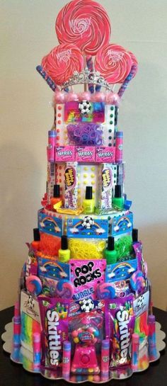 a multi - tiered cake made out of candy