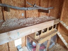 the inside of a building with wood framing and insulation in place for birds to eat