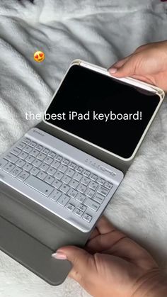 a person holding an open laptop computer on top of a white blanket with the text, the best pad keyboard