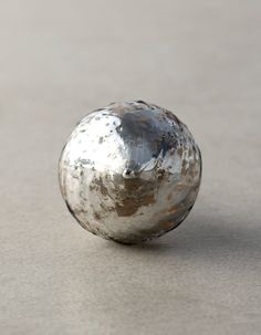 an old metal ball sitting on the ground