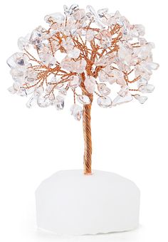 a wire tree with clear glass beads on it's branches, sitting on a white base