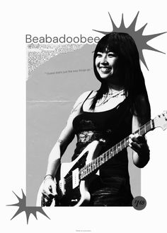 a woman holding a guitar in her hand and smiling at the camera with an advertisement behind her