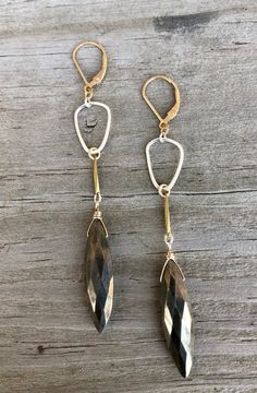 Mixed metal earrings made with sterling silver, 14 k gold filled, and a brass element. The stone is a faceted pyrite. Gold Faceted Brass Earrings, Faceted Brass Drop Earrings, Faceted Silver Brass Jewelry, Pyrite Earrings, Mixed Metal Earrings, Metal Earrings, Mixed Metals, Jewelry Earrings Dangle, Gold Filled