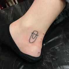 a person's foot with a small tattoo on it