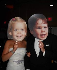 a young man and woman posing for a photo with a cardboard cut out of them