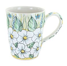 a coffee cup with flowers painted on it