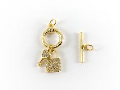 These cute little round circle toggles are real gold 18K plated with a copper base. These toggles can be wonderful made into bracelets, dainty necklaces and even used for crafts. 1 set for $6.99 3 sets for $16.99 Material: Micro pave CZ, Real gold 18K plated with copper base Size: Circle - Around 13mm Stick - Around 18mm These toggles are slow tarnish and are suitable for everyday wear. For longer lasting, please avoid contact with perfumes, body oils, and other chemicals, including household cl Gold Toggle Necklace With Charms As Gift, Gold Dainty Toggle Necklace With Clasp, Adjustable Round Toggle Necklace With Lobster Clasp, Gold Metal Toggle Necklace, Gold Dainty Toggle Necklace, Gold-tone Jewelry With Toggle Clasp, Round Gold-plated Jewelry With Toggle Clasp, Adjustable Yellow Gold Toggle Necklace Gift, Gold Toggle Necklace With Spring Ring Clasp As Gift