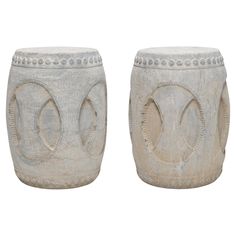 two white vases sitting next to each other