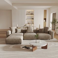 a living room filled with furniture next to a white table and wall mounted bookshelf