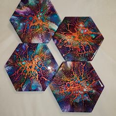 three hexagonal plates with colorful designs on them