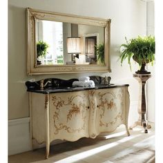 an ornately decorated dresser with mirror and potted plant