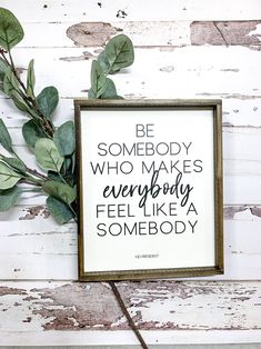 a framed sign that says be somebody who makes everybody feel like a somebody with leaves on it