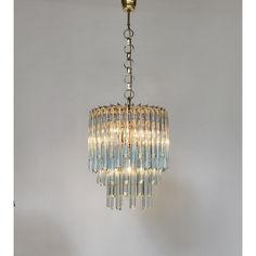 a chandelier hanging from the ceiling with lights on it's sides and one light in the middle